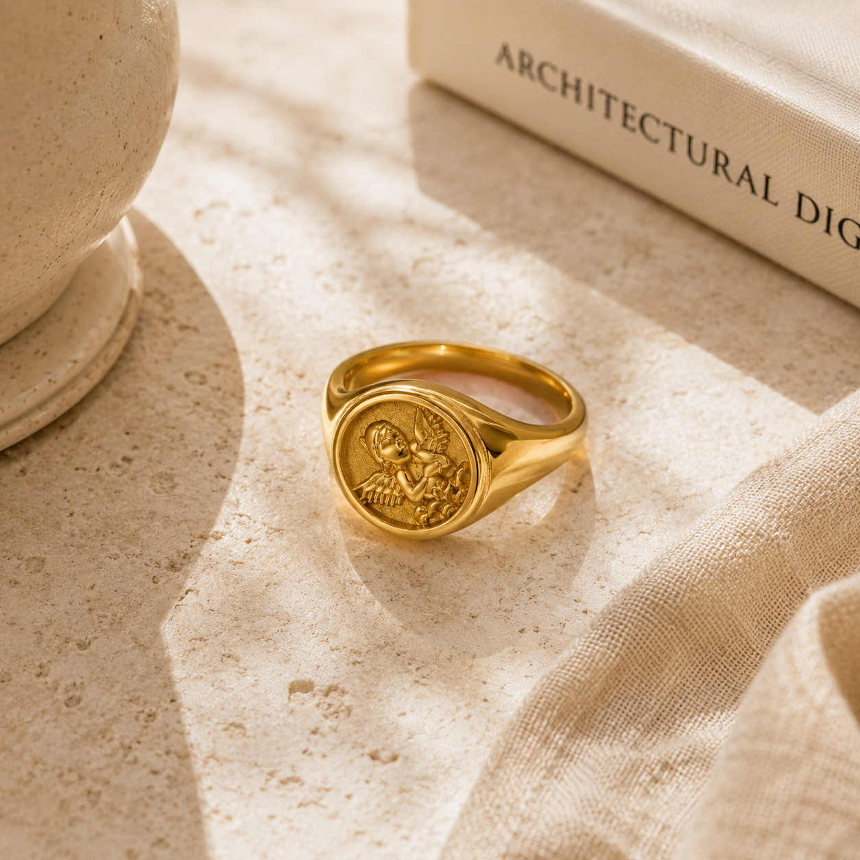 Gold signet ring with angel design, elegant jewelry for timeless style
